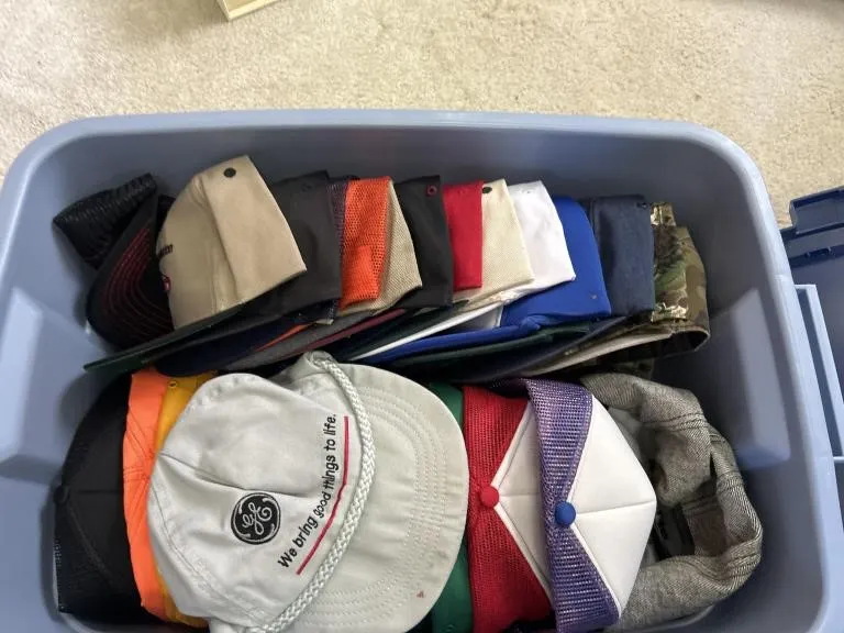 Rubbermaid Tote Filled With Hats.