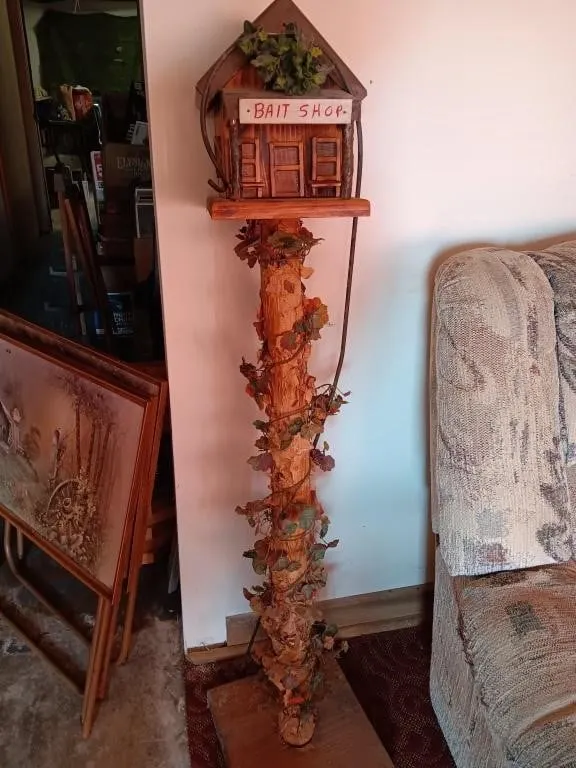 Bait Shop birdhouse mounted in pole approximately