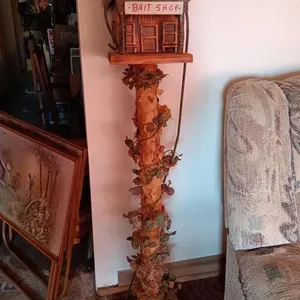 Bait Shop birdhouse mounted in pole approximately