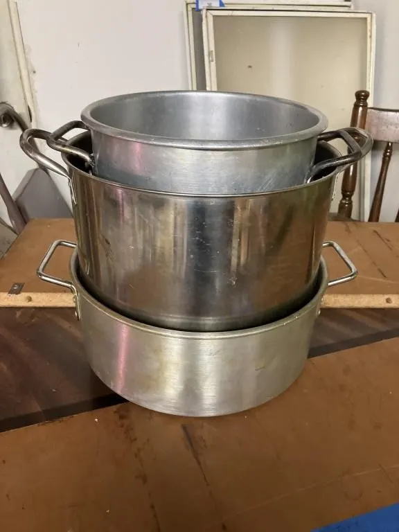 Three Metal stock pans. Variety of sizes