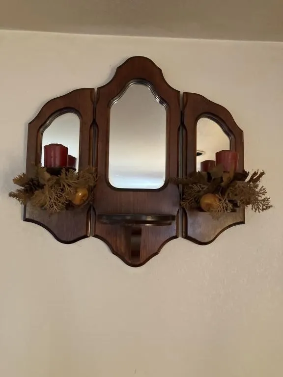Wooden mirrored wall decor with candles and