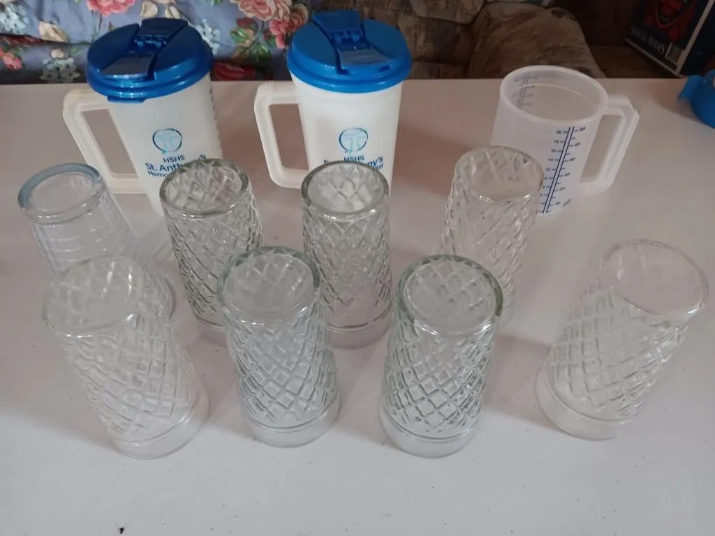 Assorted drinking Glasses and water measuring