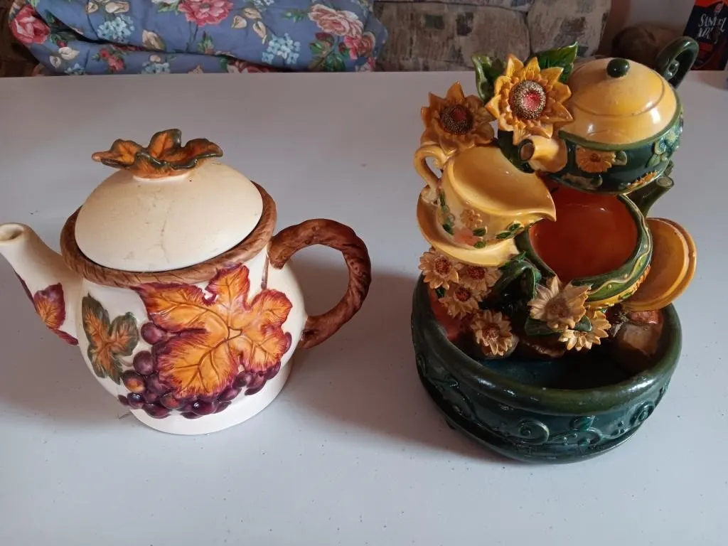 Ornamental tea pots, one is a table top water