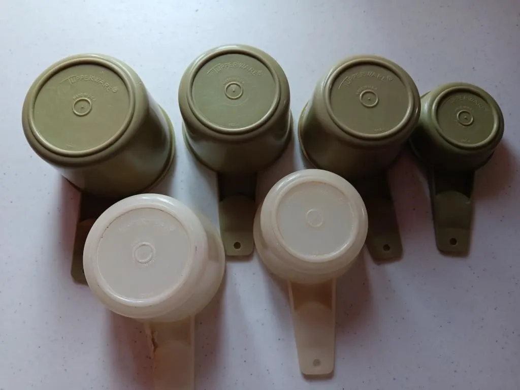 Tupperware measuring cups and kitchen utensils.