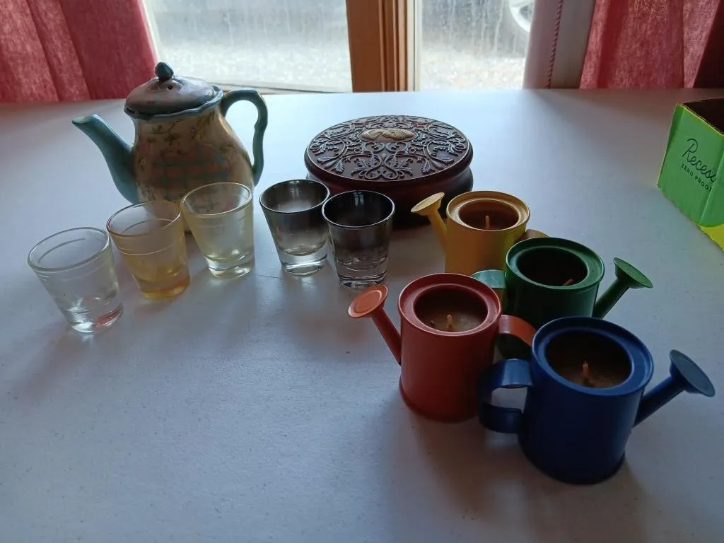 Candles, glasses, teapot, storage container.