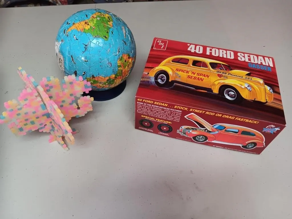 Ford Model Kit, puzzle globe, tree. Appears to