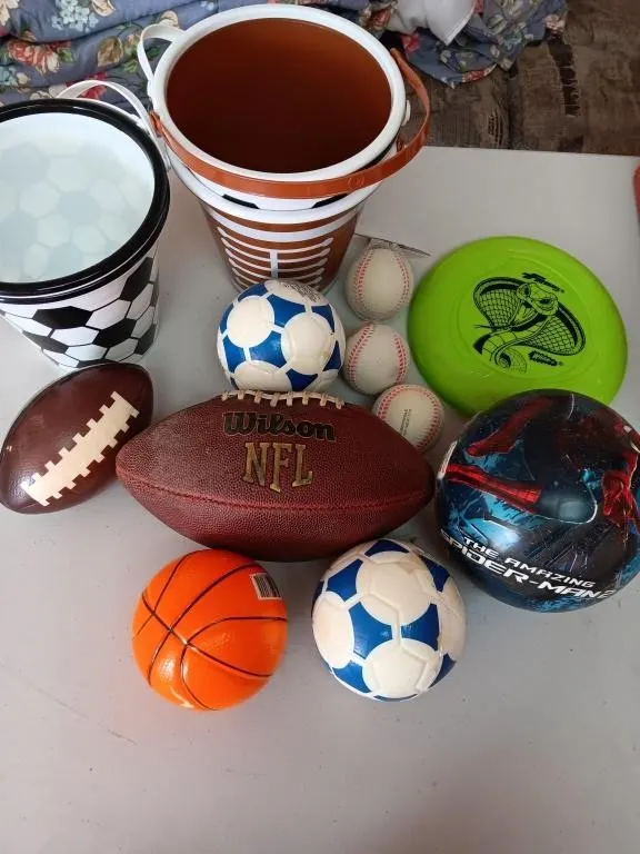Sports balls and buckets. Two football and three
