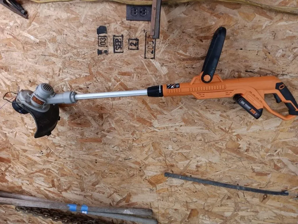 Black + Decker weed trimmer with battery. Works.