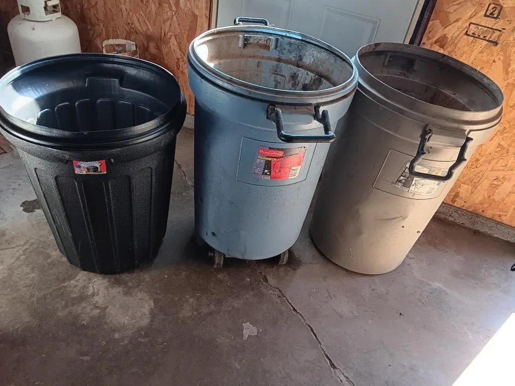 Three garbage bins. Two Rubbermaid 32 gallon and