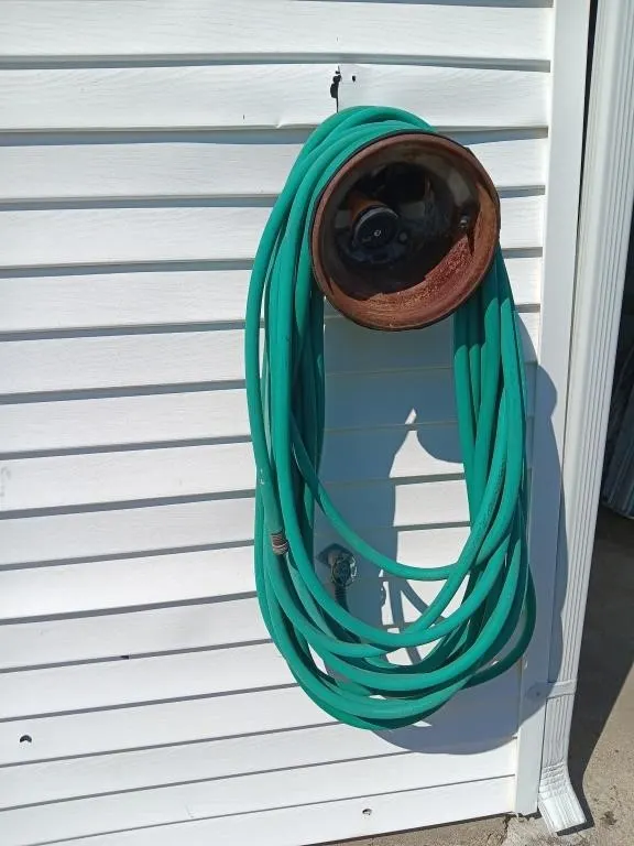 Garden Hose, holder, and sprayer. Buyer must take