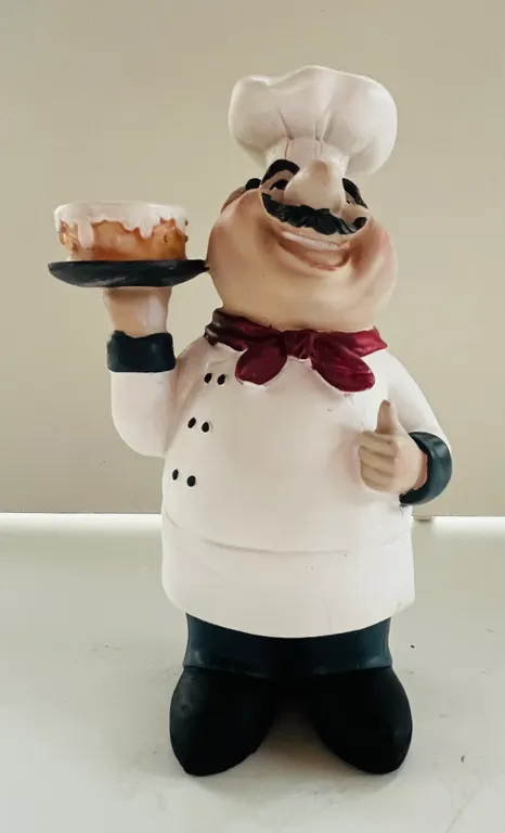 Chef Figurine Holding Cake