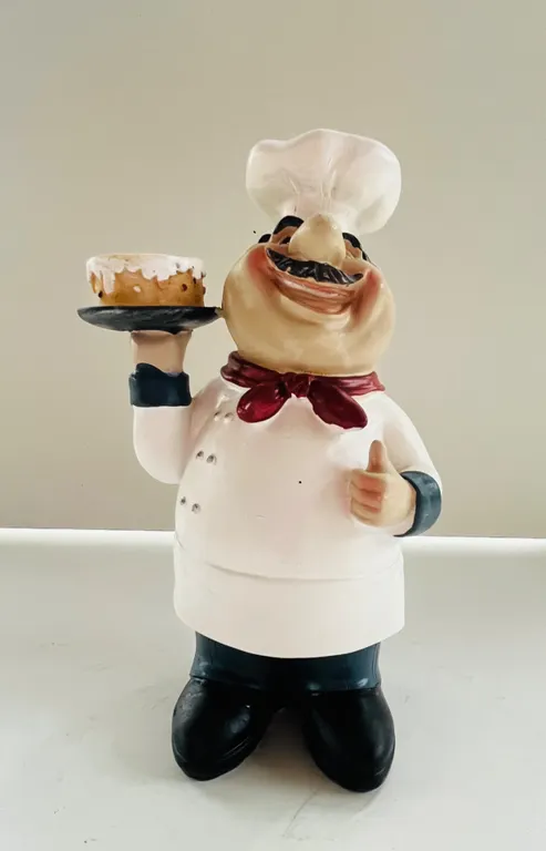 Chef Figurine Holding Cake
