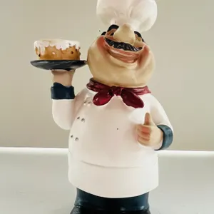 Chef Figurine Holding Cake