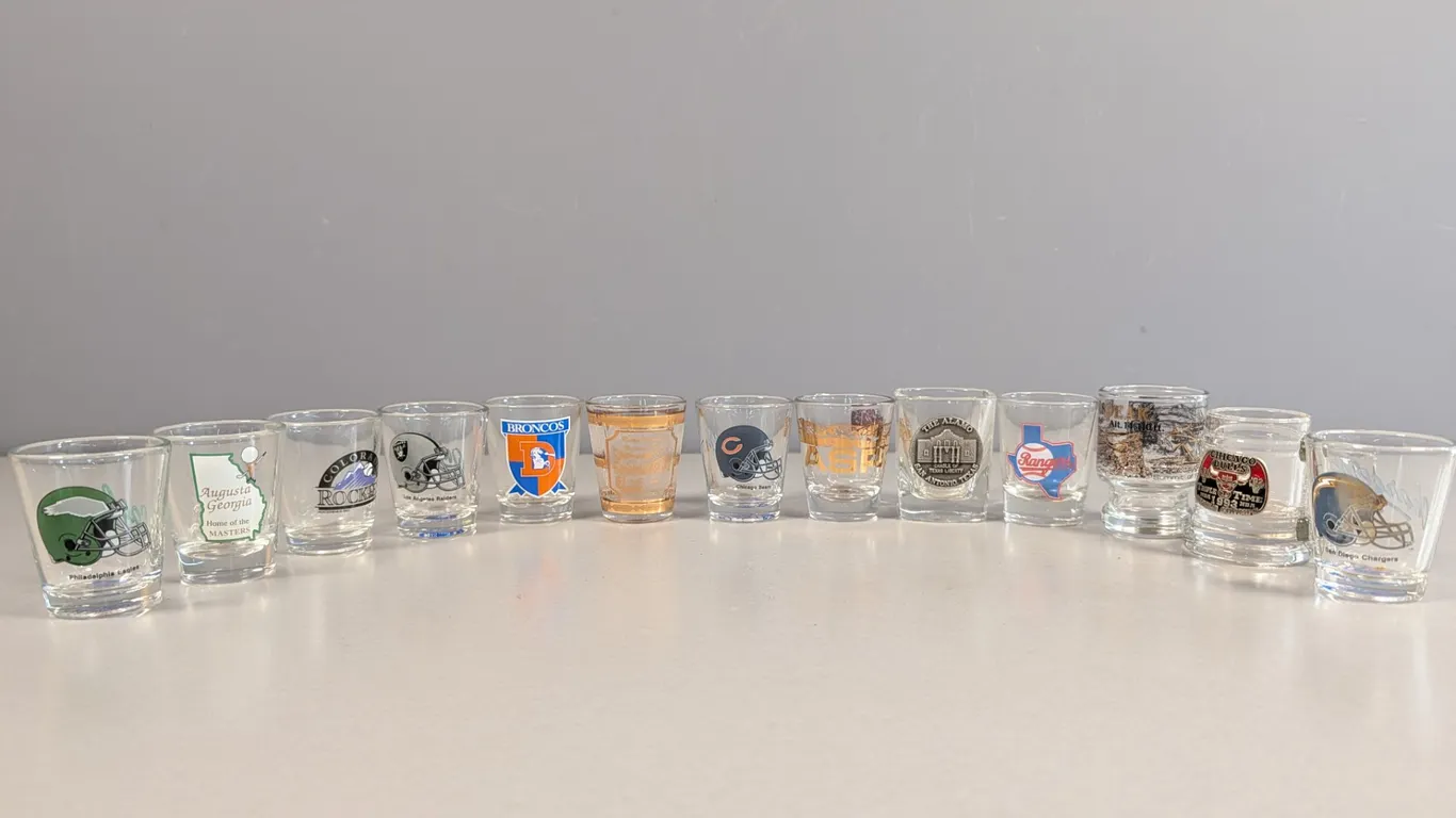 Collection of 13 Assorted Sports Teams and Souvenir Shot Glasses