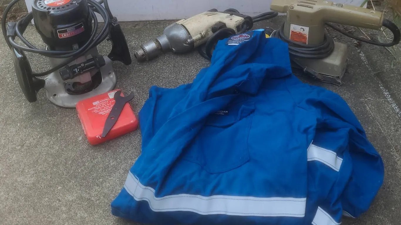Working Power Tools and Guardian Protective Coveralls XL