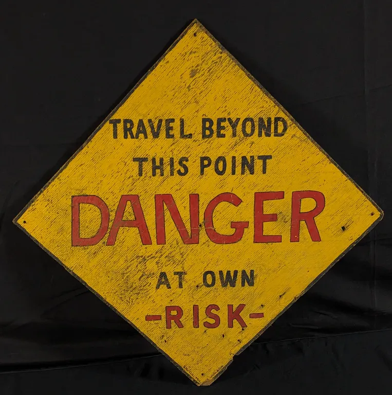 --MOTORCYCLE CLUB? -- PLYWOOD SIGN DANGER TRAVEL BEYOND THIS POINT AT OWN RISK!
