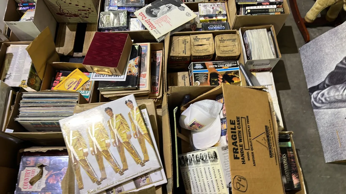 PALLET OF ASSORTED ITEMS INCLUDING ELVIS COLLECTABLE ITEMS, CASSETTES, NEWSPAPERS AND MORE