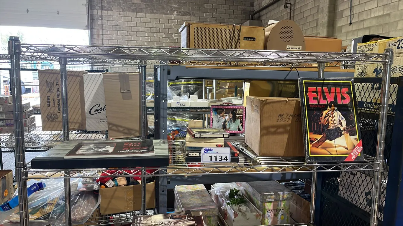 SHLEF OF ASSORTED ELVIS PRESLEY COLLECTABLE ITEMS INCLUDING MUSICAL POP UP BOOKS, CDS AND MORE