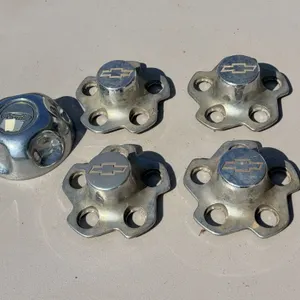 Four Chevy and One Ford Hubcap