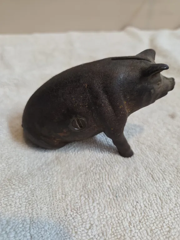 Vintage cast iron seated pig coinbank