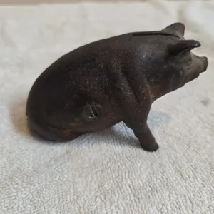 Vintage cast iron seated pig coinbank