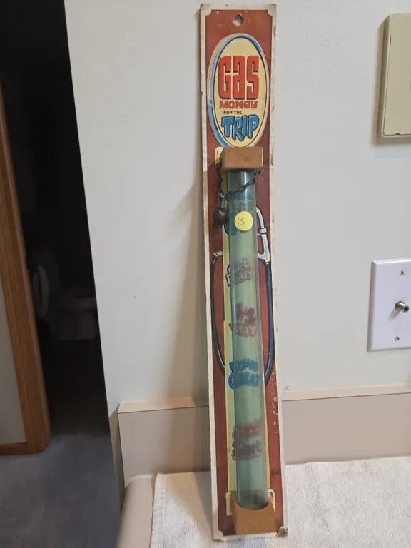 Vintage novelty coinbank, featuring a gas money for the trip gas pump theme.