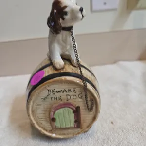 Vintage ceramic coinbase, featuring a puppy, sitting on a barrel with a phrase beware of the dog