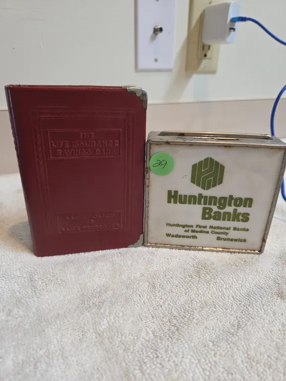 2 vintage metal coin banks with bank advertisements