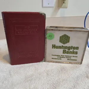 2 vintage metal coin banks with bank advertisements