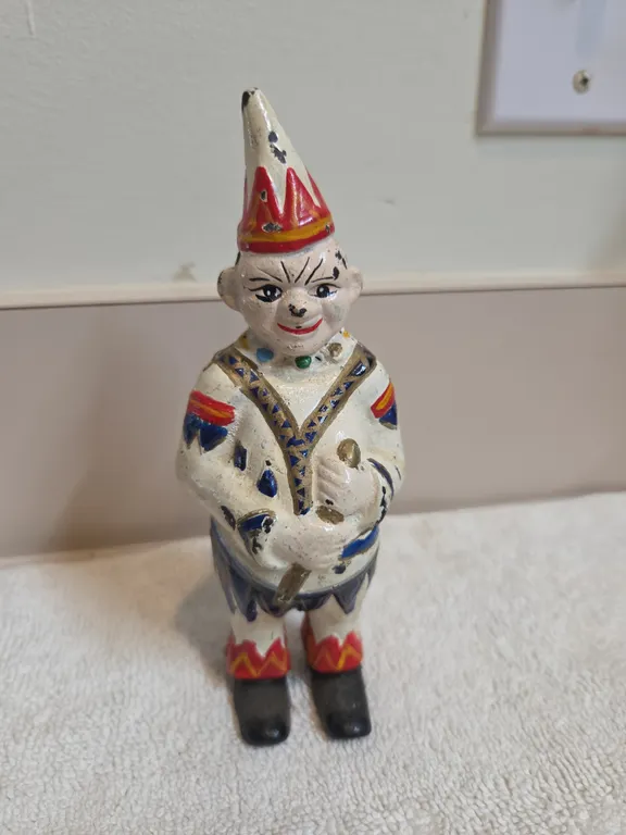 Antique cast iron circus clown or jester penny coinbank. Manufactured by the a f c williams company,