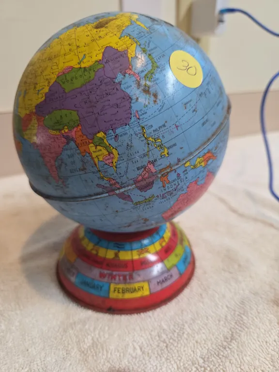 Vintage metal globe coin bank