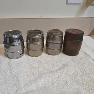 4 vintage metal barrel banks with bank advertisement