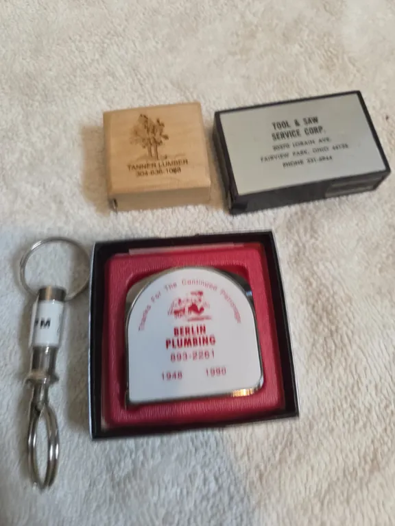 Assorted vintage measuring tapes and leveler advertisement.