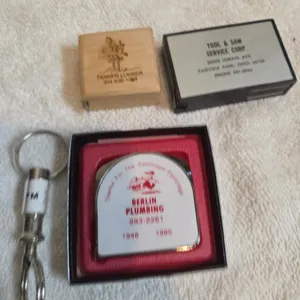 Assorted vintage measuring tapes and leveler advertisement.