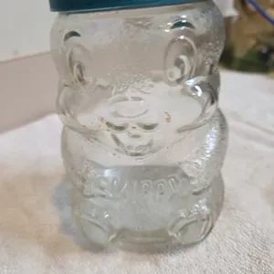 Vintage 1990s, Skippy, peanut butter glass jar coin. Bake shaped like a bear with teal. Plastic lid.