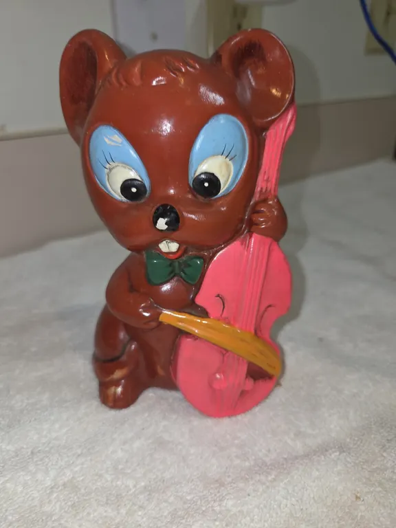 Vintage ceramic coin bank figurine of a brown mouse paint, playing a bright pink cello