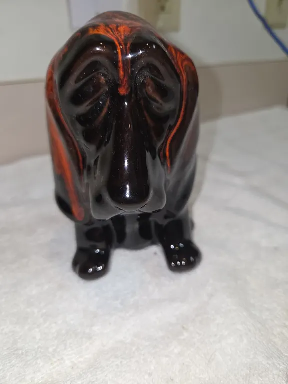 Vintage Canuck, pottery basket hound dog coinbank.
From Niagara Falls.