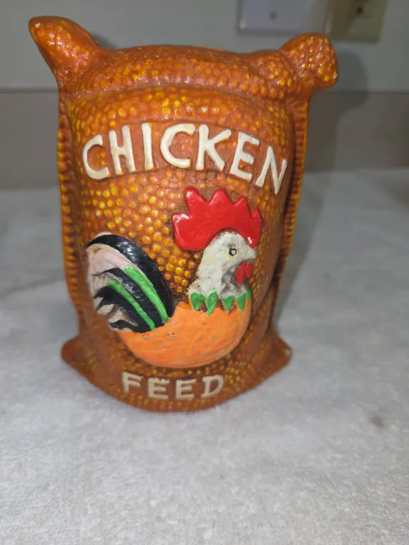 Vintage ceramic coinbase shaped lake, small sack of chicken feed.