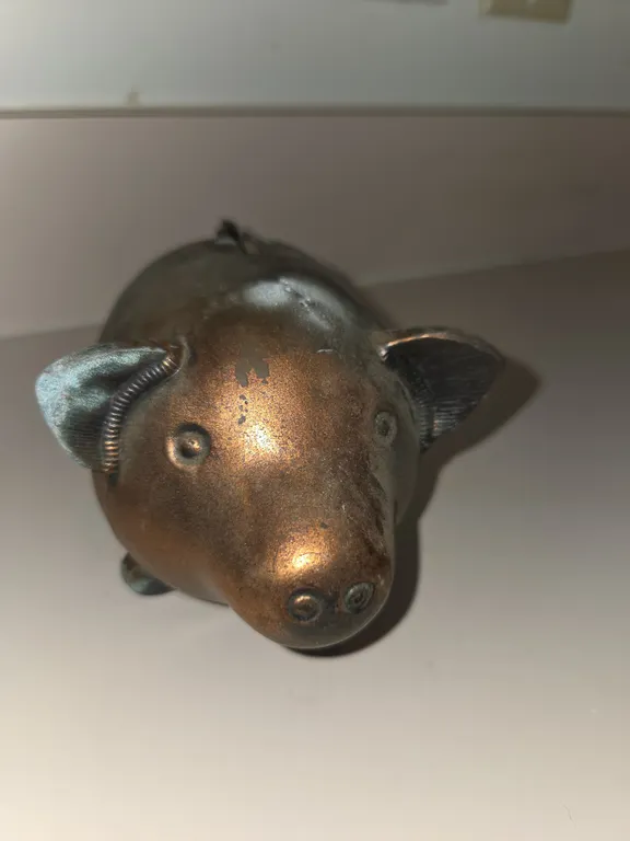 Vintage cast metal piggy bank shaped like a pig. Copper/bronze finish