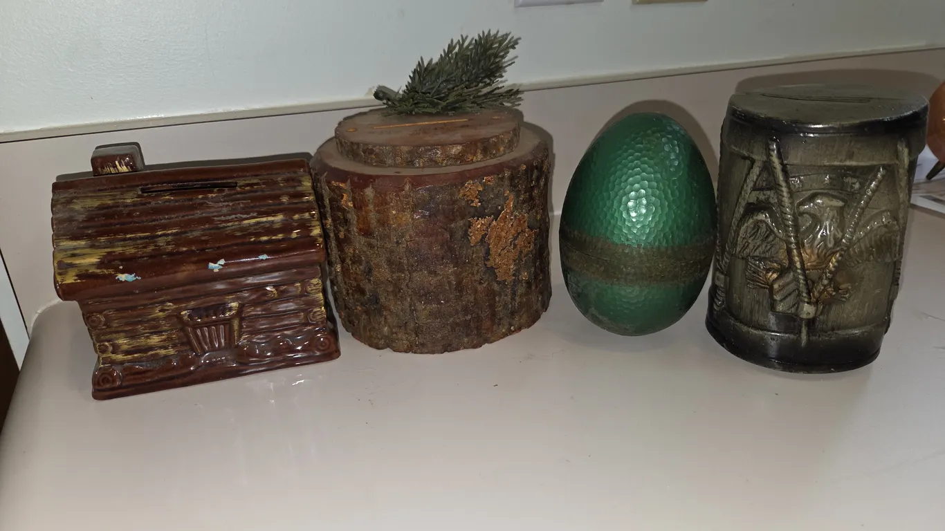 4 assorted ceramic, wood, and plastic coin banks.