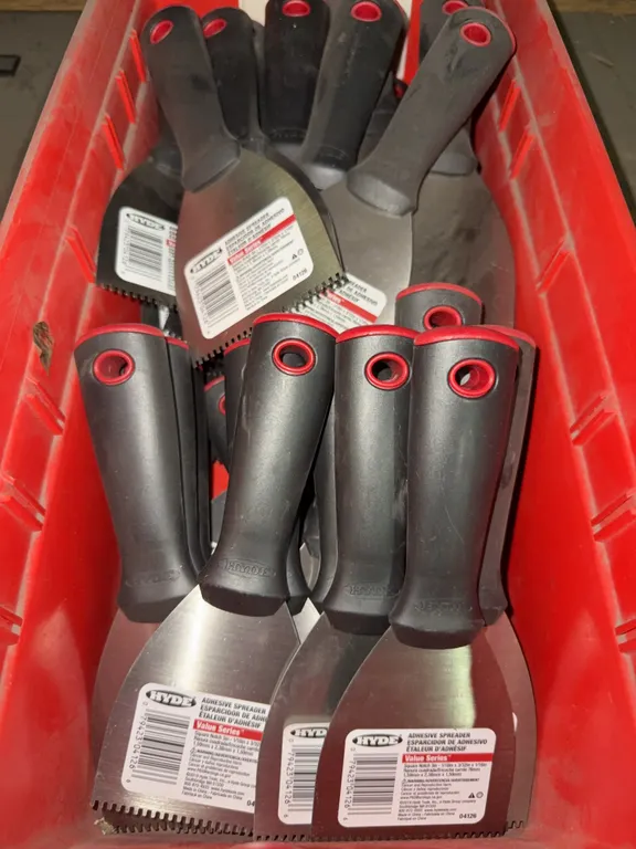 Bin of 3 inch adhesive spreaders