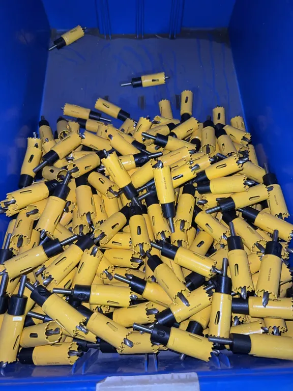 Bin of 1” hole saw bits with arbor