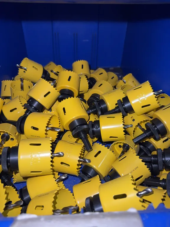 Bin of 2 1/8” hole saw bits with arbor