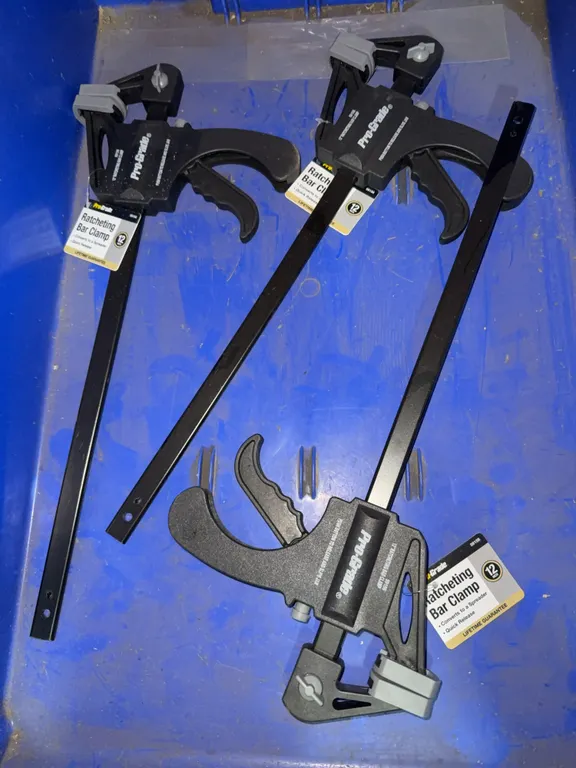 Bin of pro grade 12” ratcheting bar clamps