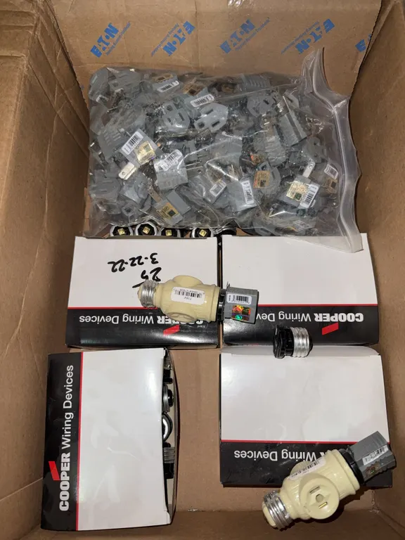 Box of miscellaneous electrical adapters, and white fixture adapters