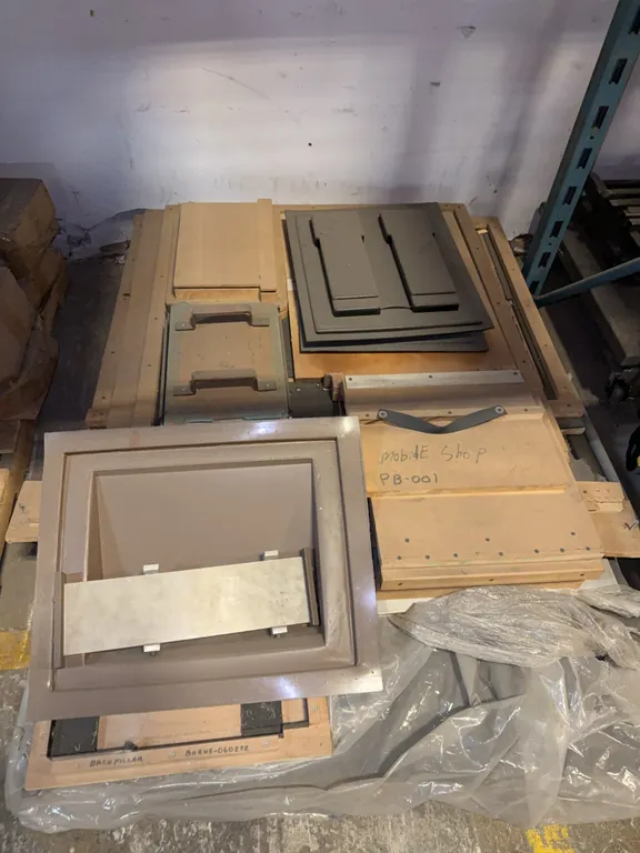 Pallet of wood, jigs, and presses