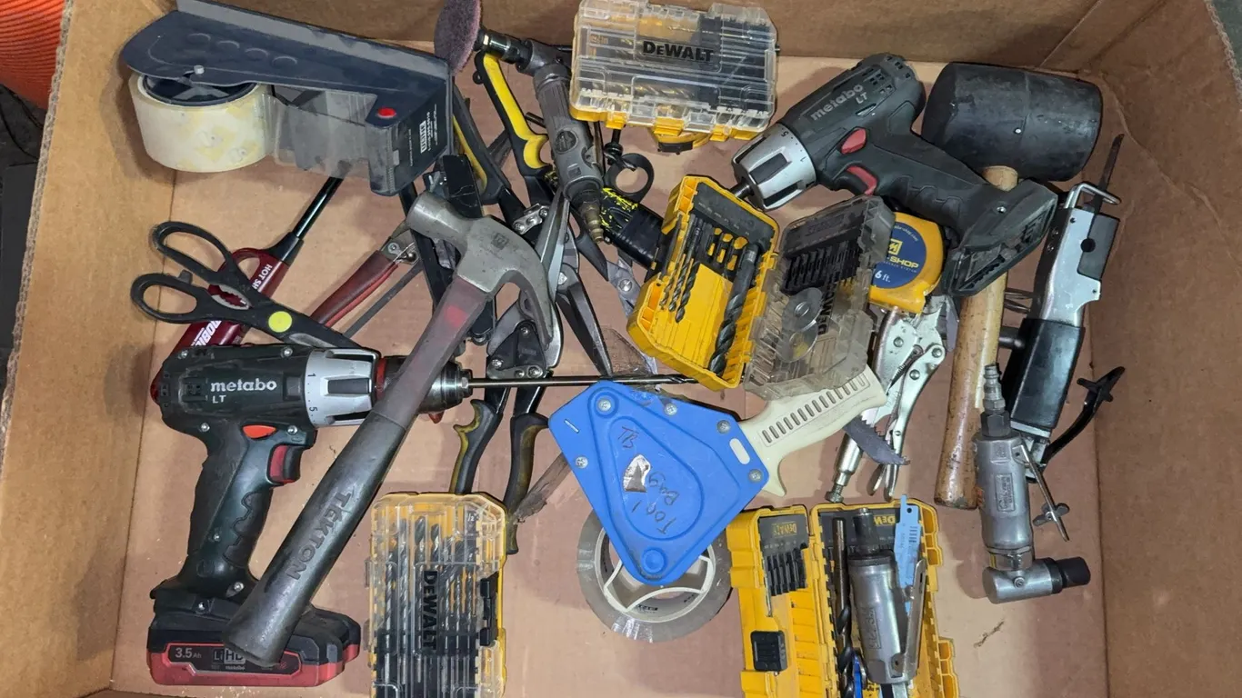 Box of miscellaneous tools, drillbits, drills, and hammers