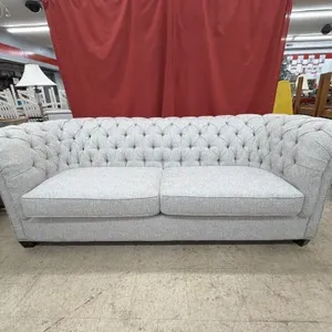 Grey tufted Chesterfield sofa