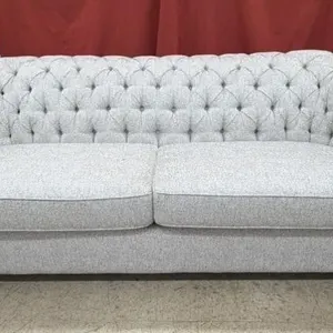 Grey tufted Chesterfield sofa