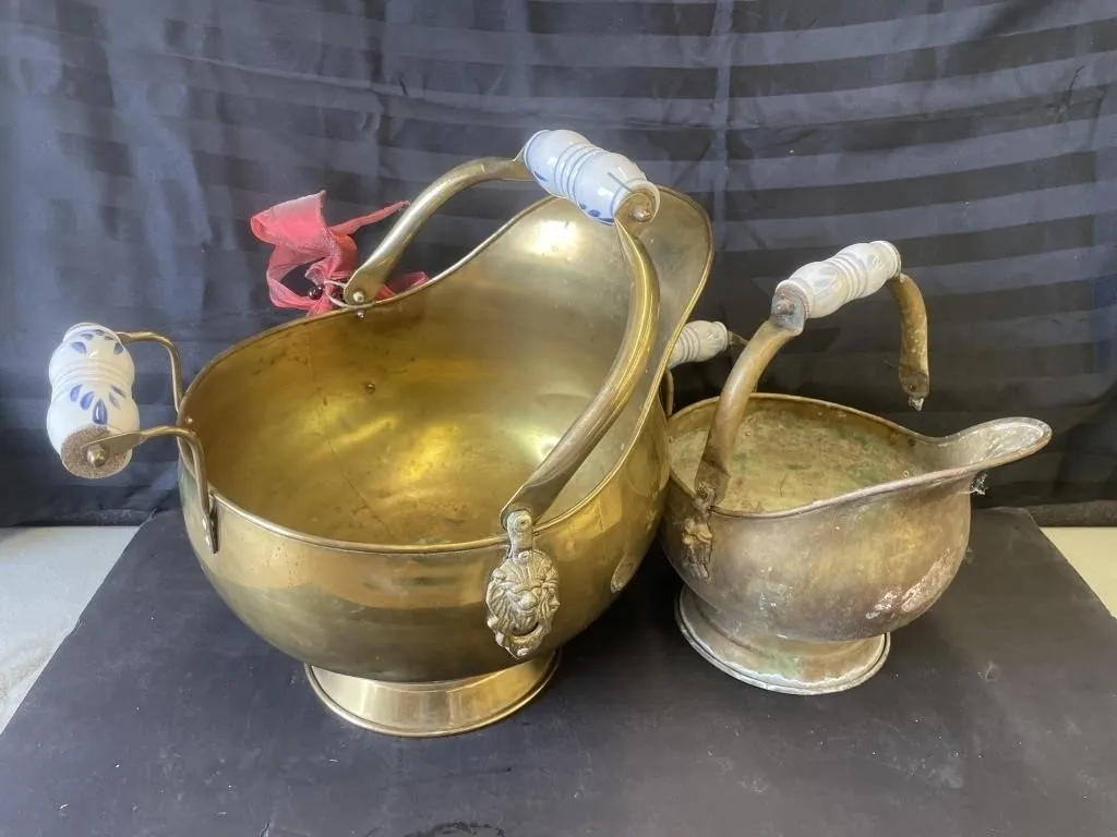 Vintage helmet-style brass coal scuttles.